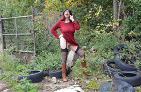 Horny mature Barby spreads ass in stockings & boots in naked outdoor upskirt
