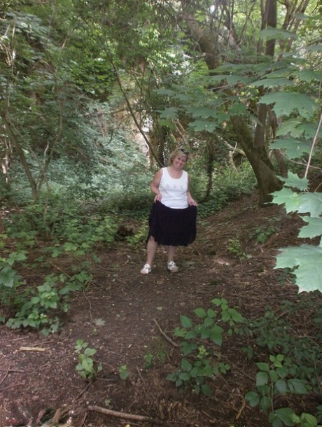 Mature amateur whore Caro masturbating on the bench in the woods