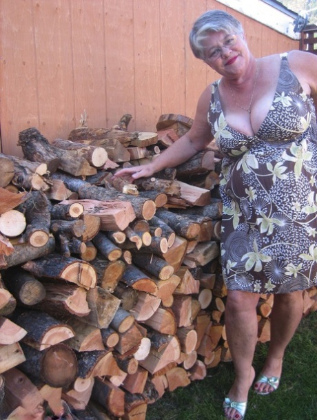 Brazen older granny strips off by the wood pile to show off BBW tits & big ass
