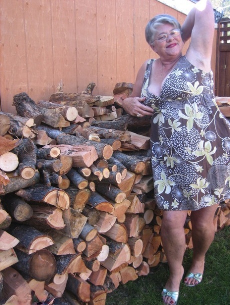 Brazen older granny strips off by the wood pile to show off BBW tits & big ass