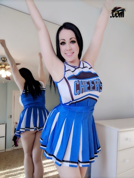 Dark-haired cheerleader Kayla Kiss uncovers her big natural tits in OTK socks