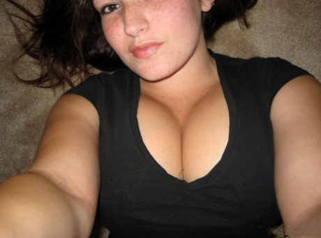 Amateur girl licks her lips while lifting up her shirt during self shot action