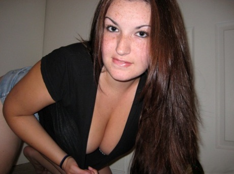 Amateur girl licks her lips while lifting up her shirt during self shot action