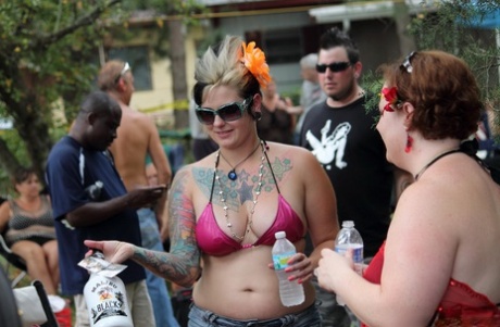 Amateur girls and strippers get naked on an outdoor stage at an adult event