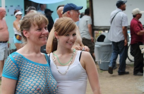 Amateur girls and strippers get naked on an outdoor stage at an adult event