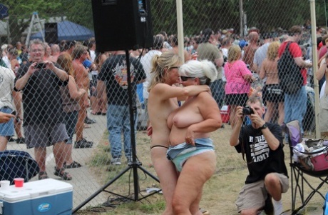 Amateur girls and strippers get naked on an outdoor stage at an adult event