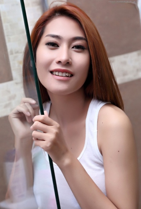 Asian redhead Linlin exposes her great body while in the shower