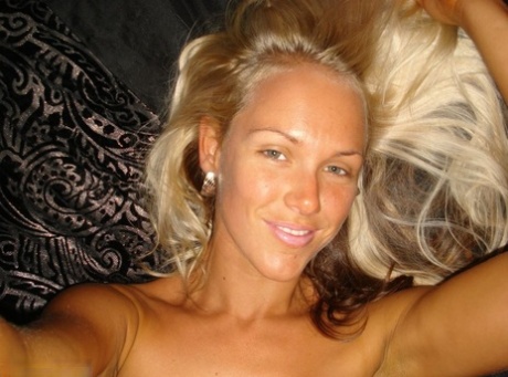 Hot blonde Aussie Jewel displays her big boobs while taking nude selfies