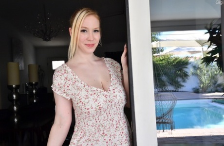 Natural blonde Gigi unveils her hooters before masturbating in the nude