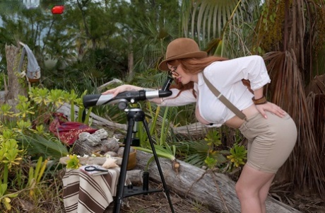 Sexy redhead explorer Lily Madison unveils her massive big tits in the wild
