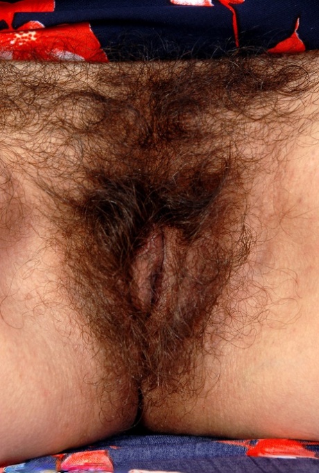 Old big breasted granny takes off her skirt and shows off her old hairy muff.