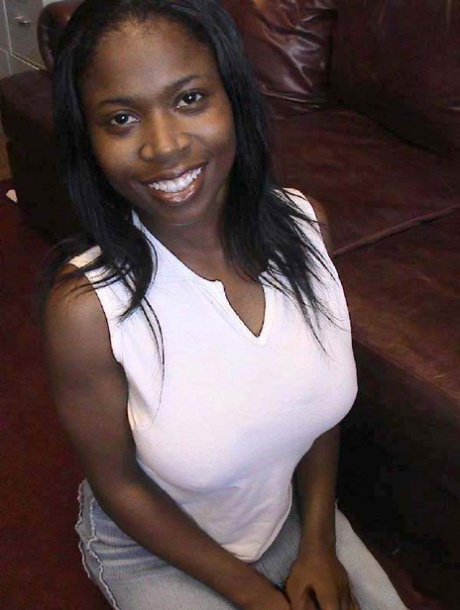 Ebony cutie Carla unveiling her huge natural breasts and round booty