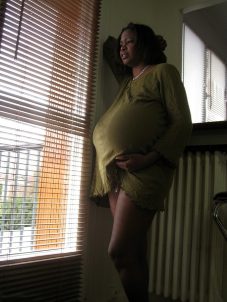 Ebony wife Miosotis Claribel strips and exposes her tremendous breasts