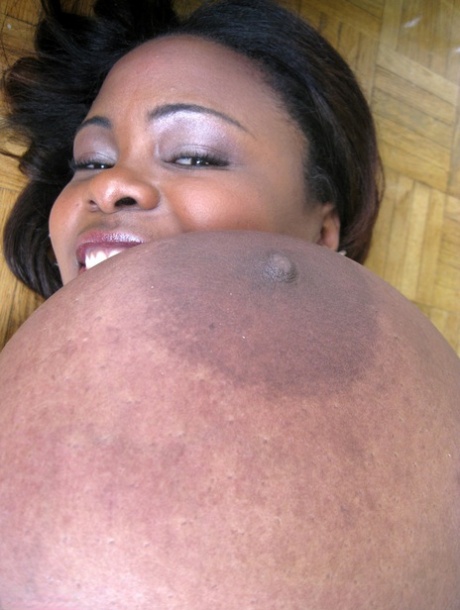 Ebony wife Miosotis Claribel strips and exposes her tremendous breasts