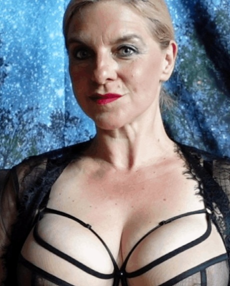 Stunning mature blonde flaunts her huge cleavage and sexy ass in a solo