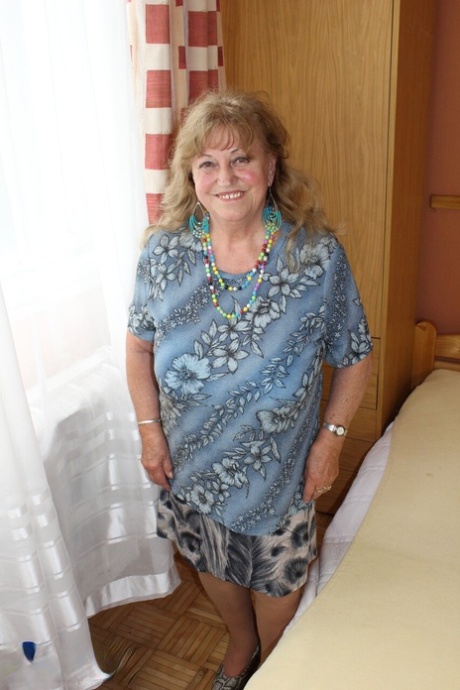 Charming granny Katerina stripping and showing her huge saggy boobs