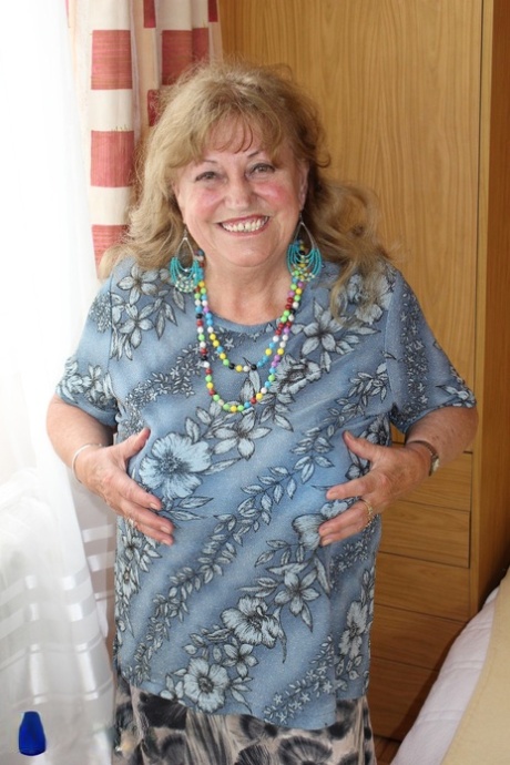Charming granny Katerina stripping and showing her huge saggy boobs