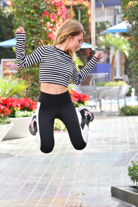 Stunning teen Macy flashes her natural tits while posing in public